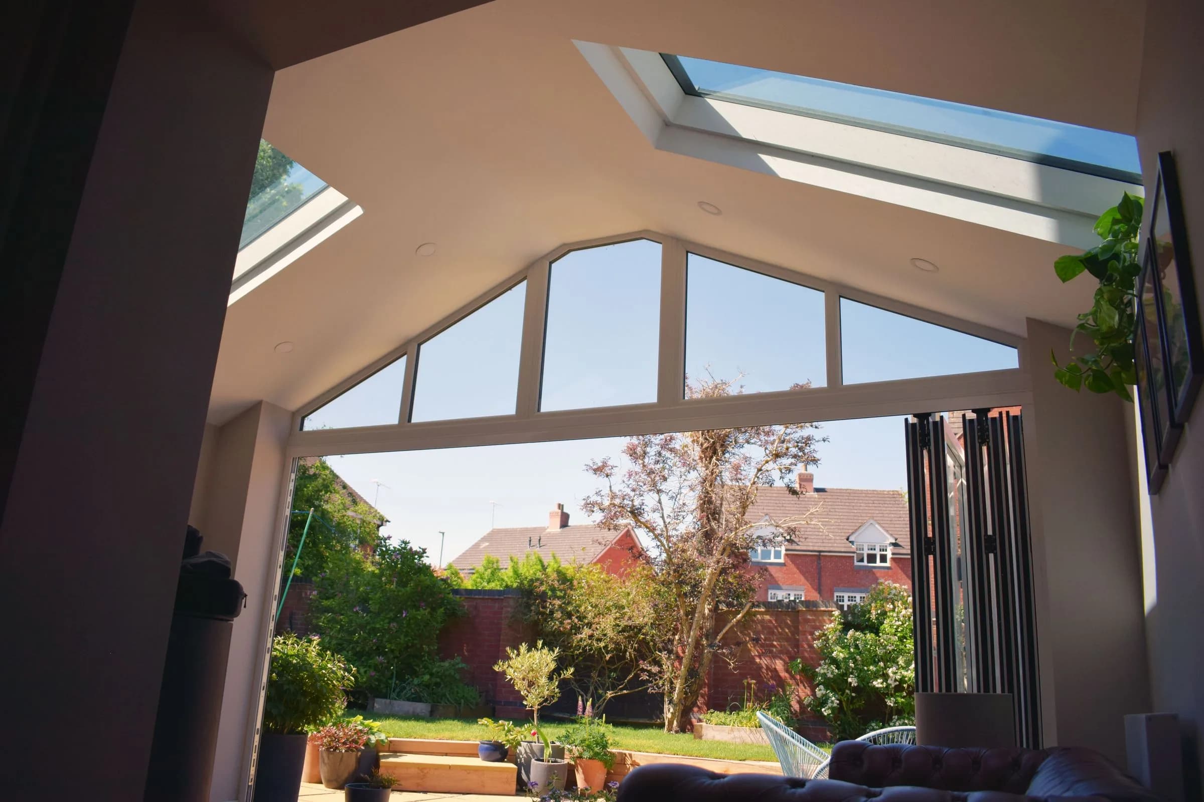 The vaulted plastered ceiling of a SupaLite lightweight tiled conservatory roof, with roof windows and a glazed gable.