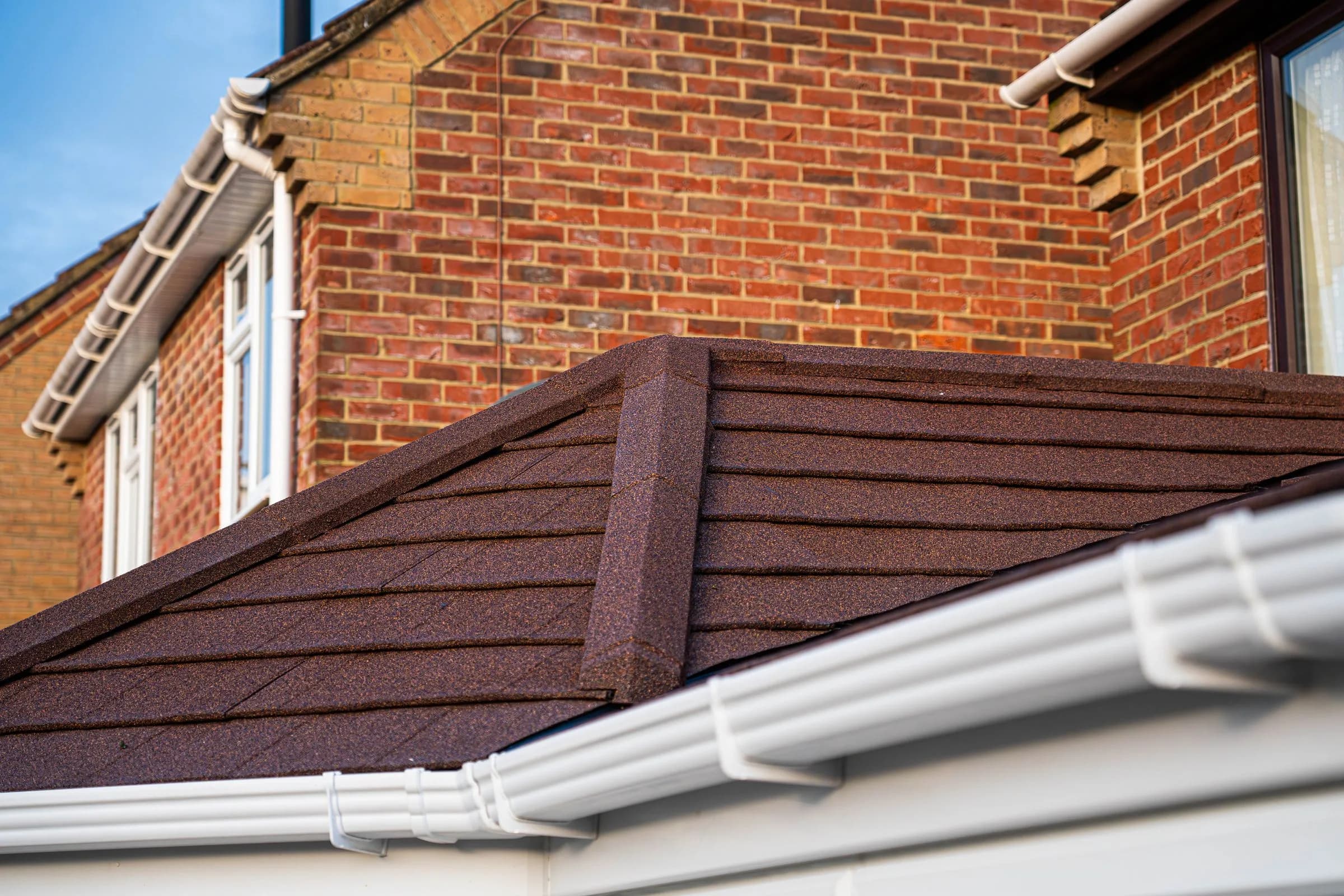The terracotta tile courses and guttering along the eaves of a WarmerRoof conservatory roof.